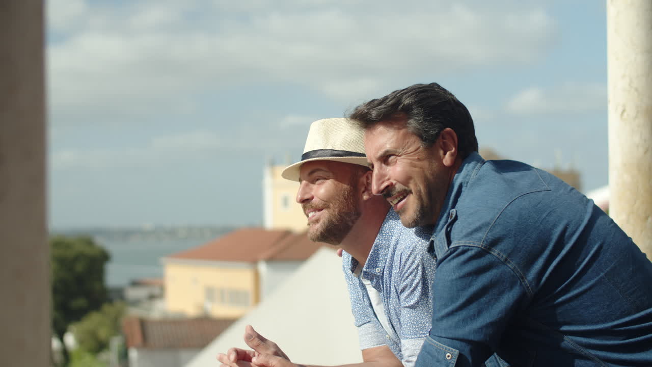 Slow motion of happy gay couple looking at city from view point