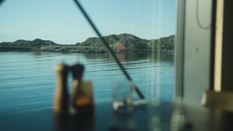 Shot-from-restaurant-with-dramatic-seaside-view-and-table-in-foreground,-close-up