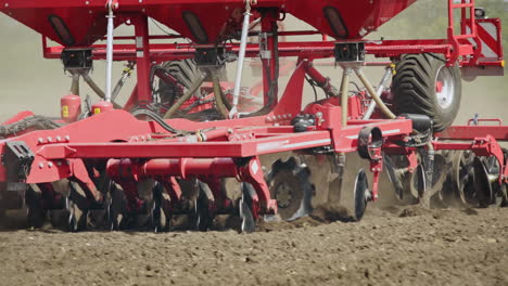 sowing machine plowing and sowing seeds in soil on rural field. farming industry