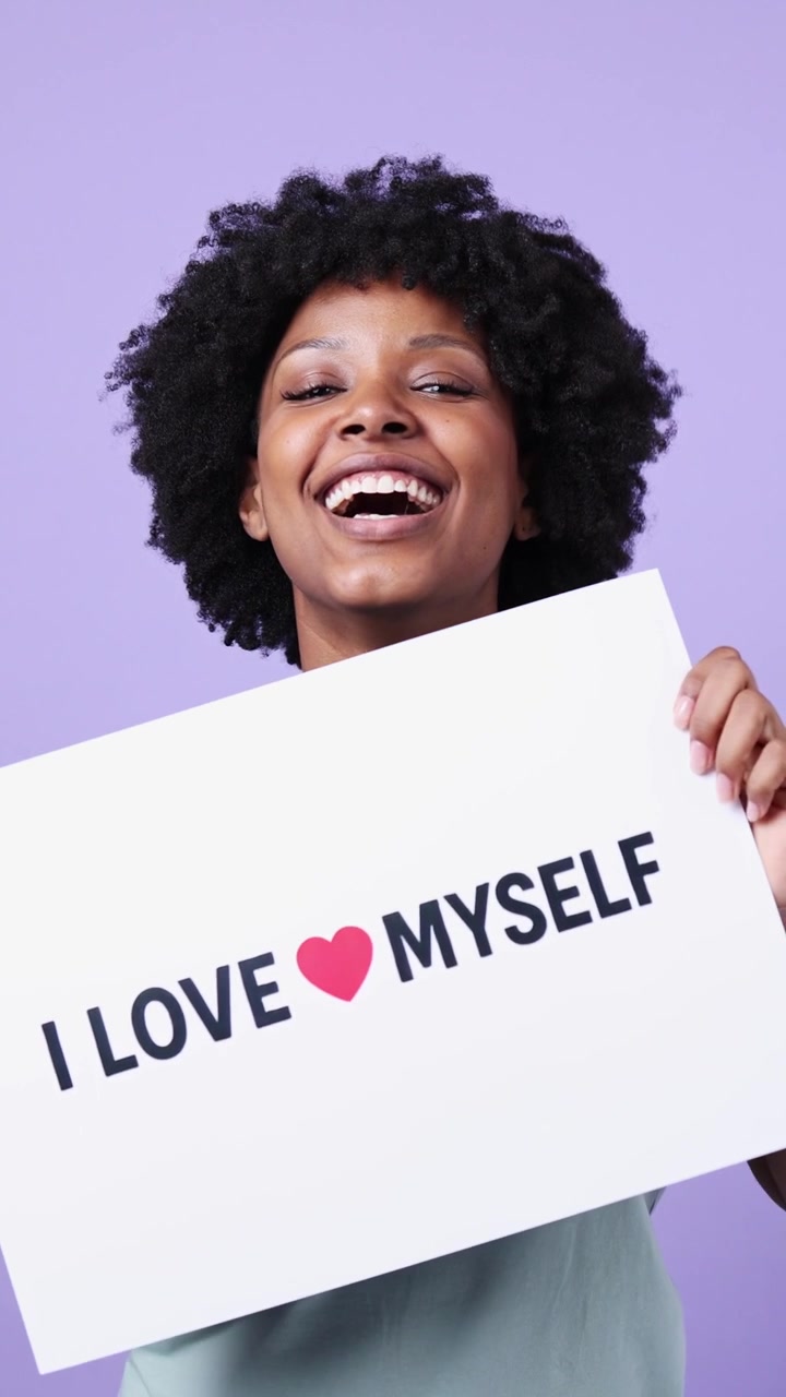 Happy Young Black Woman Holding "I Love Myself" Sign