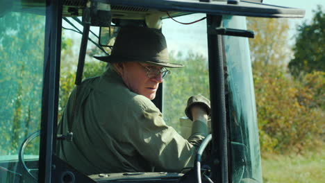 Farmer-Manoeuvres-Controls-in-Tractor-Cab