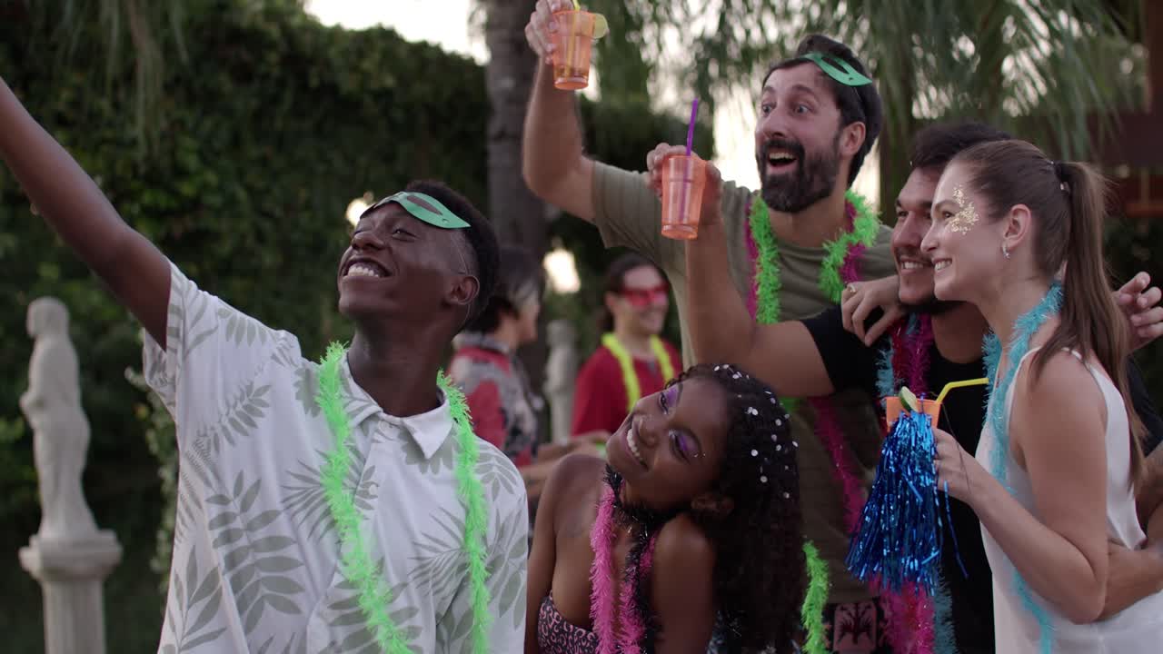 Friends celebrating carnival with a selfie and drinks