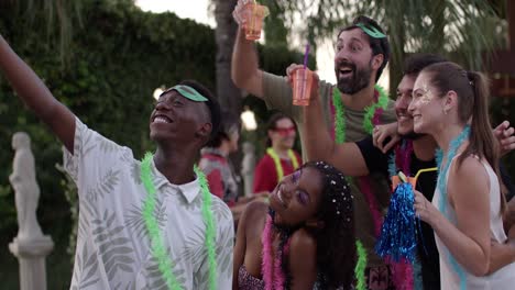 friends celebrating carnival with a selfie and drinks