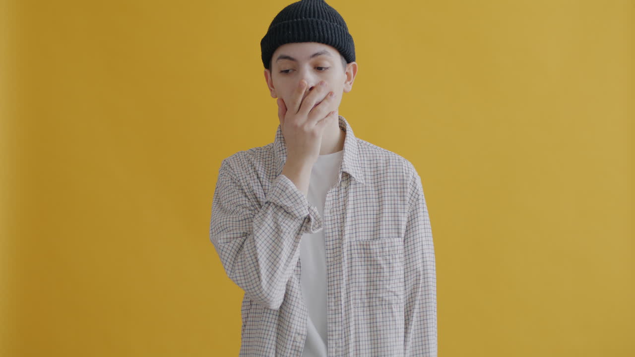 Young Man with Neutral Expression in Studio