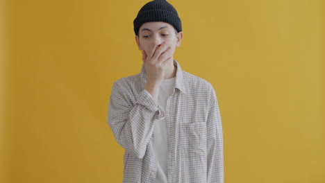 young man with neutral expression in studio