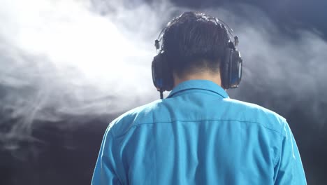 man wearing headphones, back view