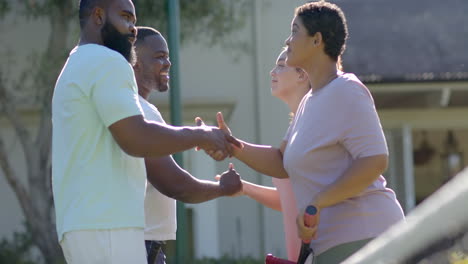 shaking hands, diverse friends greeting each other outdoors, enjoying social interaction