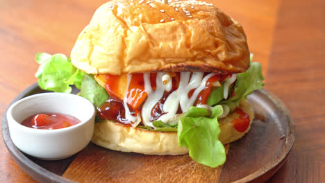 beef burger with cheese and sauce on wood plate