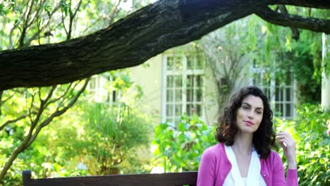 Beautiful-woman-sitting-on-bench-in-garden