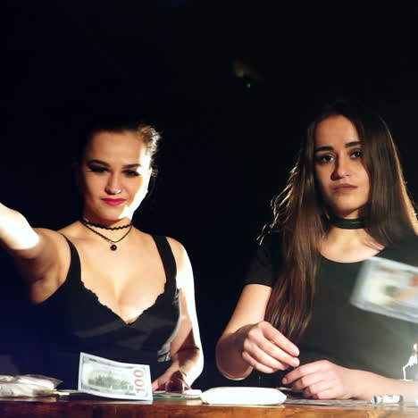 beautiful girls throwing money in the air, enjoying wealth and prosperity. young women sell drugs.