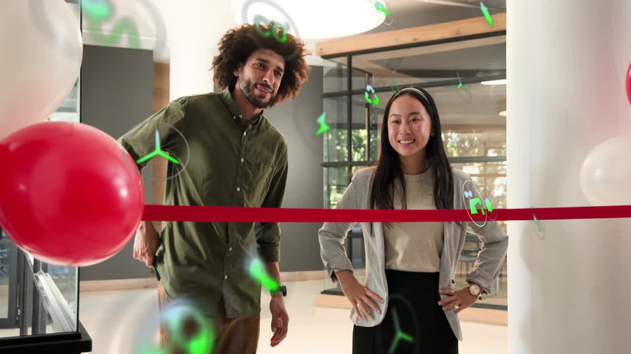 Hosts behind red ribbon talking shaking hands causing green overlays rising marking office launch