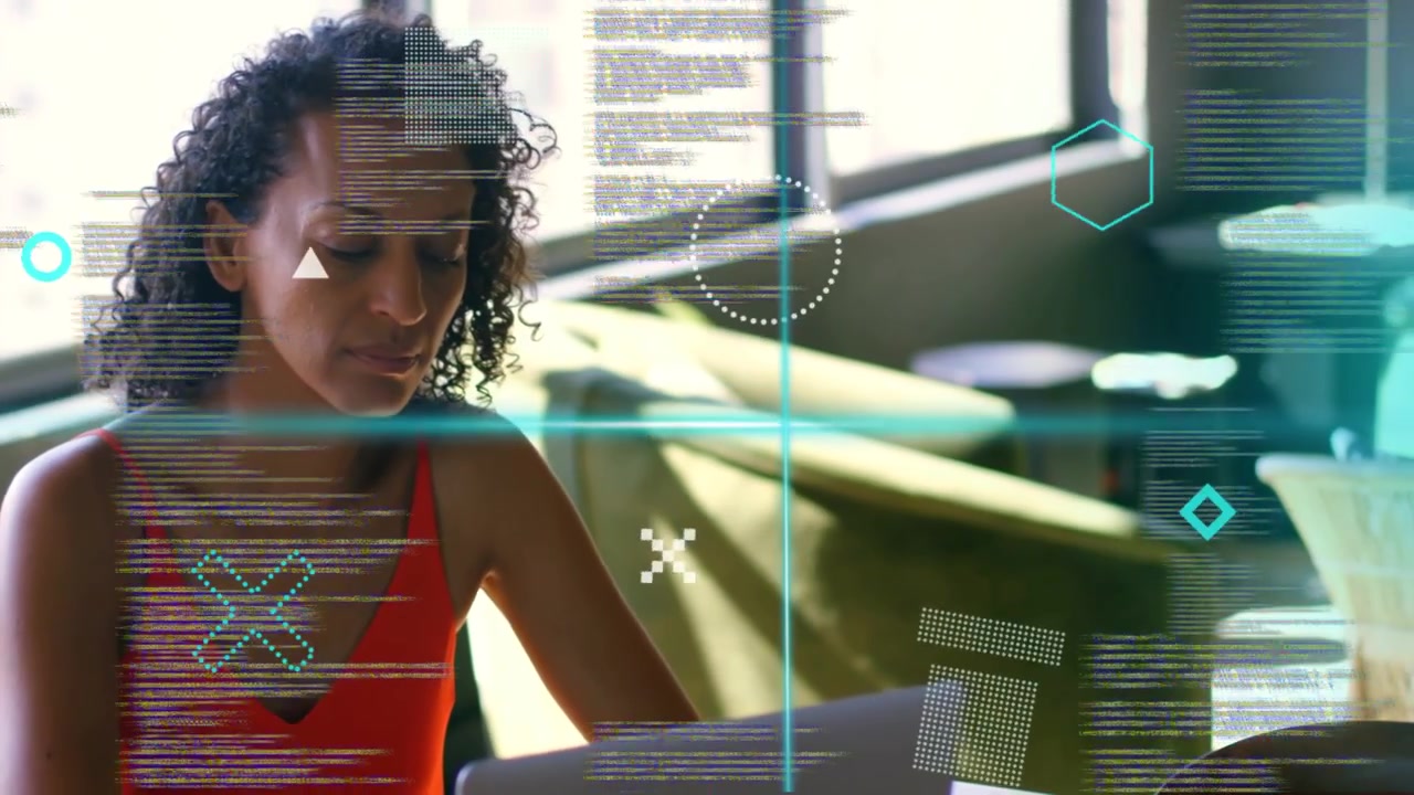 Mature woman typing in lounge, activating HUD overlays scanning code across face for tech demo