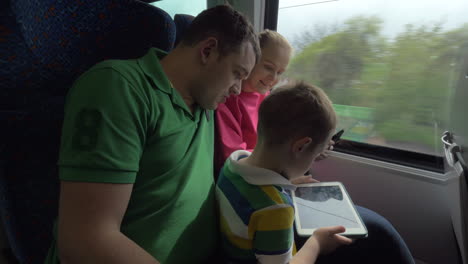 familia viajando en tren y usando tabletas digitales