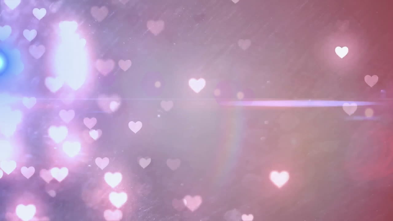 Abstract heart-shaped bokeh cluster being animated over dreamy pastel backdrop with light flares