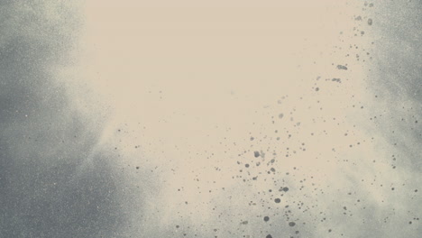 white spray from blowhole erupts with mist and foam particles flying high into blue sky