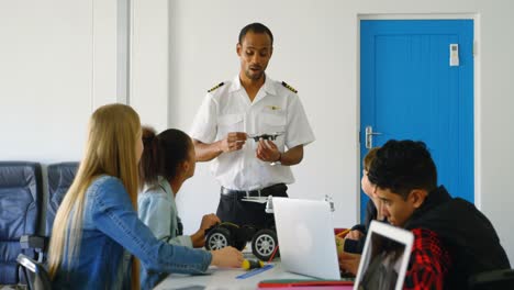 pilot giving training about drone to kids 4k