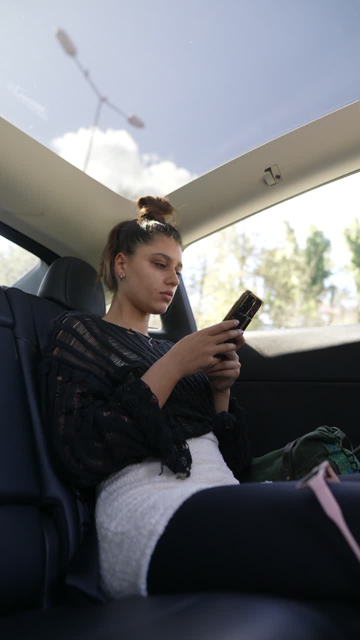 Teenager using phone in a car