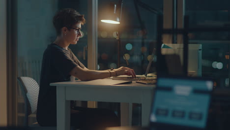 Woman Working on Laptop in the Office Late at Night