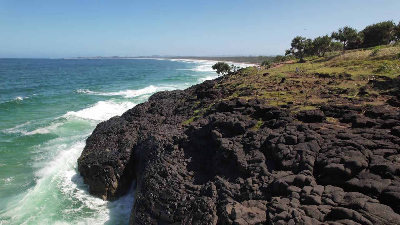 Waves Crashing On Basalt Rock Formation Of Fingal Headland On Tasman Sea Coast, NSW, Australia. drone pullback shot