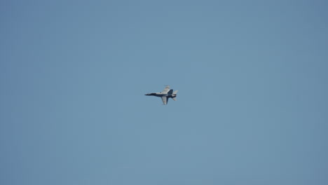 a fighter jet showcases breathtaking aerial maneuvers brilliantly against a vibrant blue sky backdrop