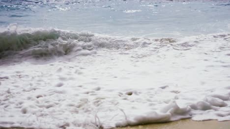 immense rolling waves crashing on the shore of kelingking beach