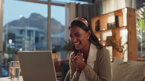 excited woman celebrating success on laptop