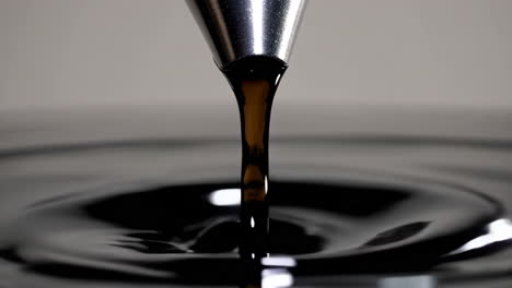 dark liquid pouring into a pool