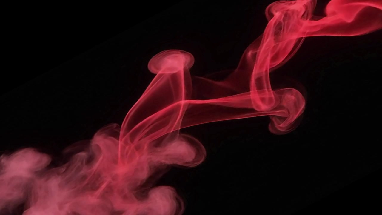 Fumo rosso astratto vorticoso su sfondo nero