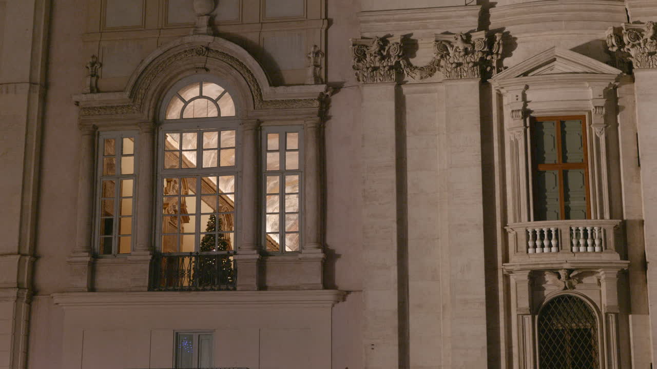 A Christmas tree in a window in Baroque church in Rome , Italy