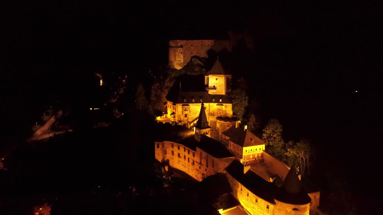 Aerial wide shot over historic Orava Castle in Slovakia at dark night - Beautiful Castles