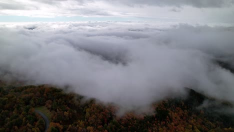 clouds above fall colors aerial near boone and blowing rock nc, north carolina