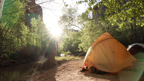 campsite by the river in the early morning sunlight