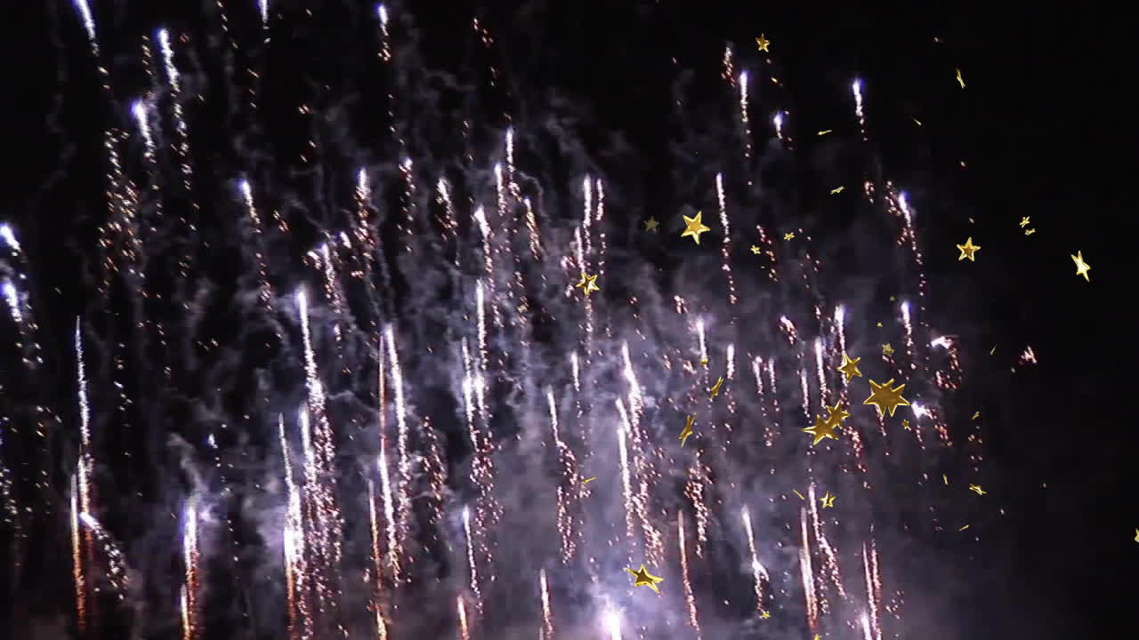 Fireworks display with golden stars animating over night sky