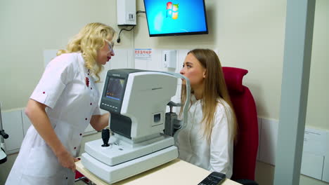 ophthalmologist examining young woman. doctor ophthalmologist checking the eye vision
