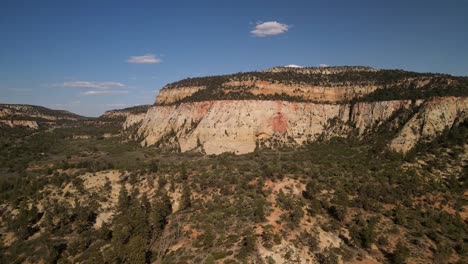 a drone, cinematic, and detailed view of a peak of the zion national park and its landscape