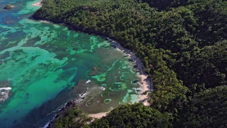 Transparent-bay-with-clear-water-and-coral-reef-at-Ermitano-Beach-in-summer