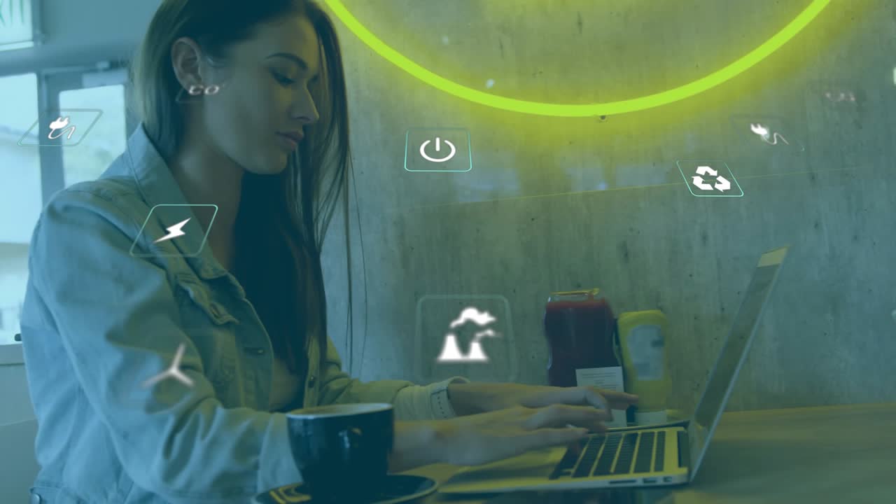 Woman typing on laptop at cafe counter, activating AR energy icons visualizing CO2 and wind data