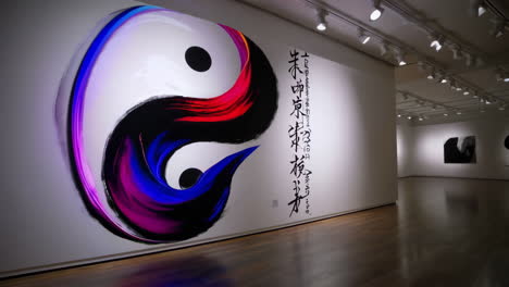 yin and yang wall art in a museum