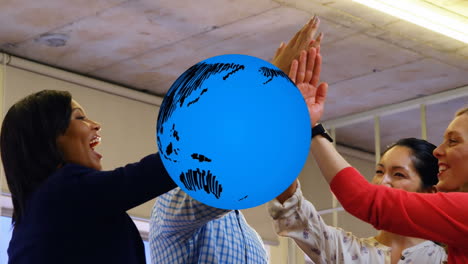 animation of globe over smiling business colleagues high fiving