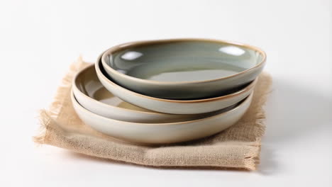 stack of ceramic bowls on burlap