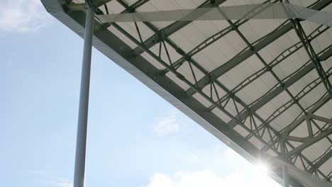 Under-the-roof-of-a-football-stadium,-clear-sky,-perspective-shot-from-below,-daylight