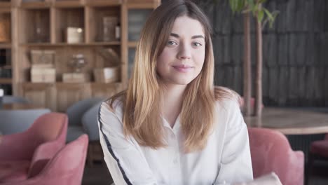 a young beautiful girl chills in the restaurant during amazing day