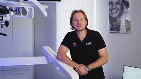portrait of male dentist. portrait of dentist standing in clinic