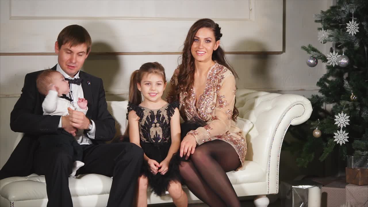 Happy Family Portrait by the Christmas Tree