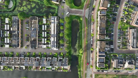 aerial birdseye view of a city landscape with rows of new houses intermixed with a waterway and streets