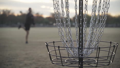 missed disc golf putt that hits the chains and hits rim of the disc golf basket cage