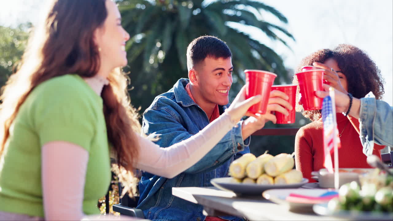 Friends celebrating with food and drinks outdoors