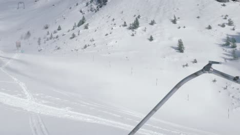 Snow-cannon-fires-artificial-snow-on-the-slopes-of-Engelberg,-Switzerland