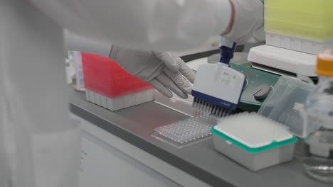 tight shot of scientist preparing samples with gloved hands