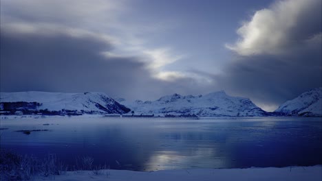 sea fog over blue fjord on blue winter day